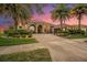 Charming single-story house with a brick driveway, stone-accented entrance, and tropical landscaping and palm trees at 568 Luna Bella Ln, New Smyrna Beach, FL 32168