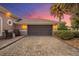 Spacious two car garage with brick paver driveway and side chairs. Tropical landscaping at 568 Luna Bella Ln, New Smyrna Beach, FL 32168