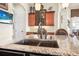Close up of kitchen island featuring granite countertops, a stainless sink, and pendant lighting at 568 Luna Bella Ln, New Smyrna Beach, FL 32168