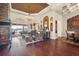 Luxury living room features high ceilings, wood floors, with leather furniture overlooking water views at 568 Luna Bella Ln, New Smyrna Beach, FL 32168