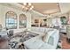 Open-concept living area with modern furnishings, hardwood floors, and views of the lake at 568 Luna Bella Ln, New Smyrna Beach, FL 32168