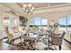 Bright living room with hardwood floors, lake views, elegant furniture, and a decorative rug at 568 Luna Bella Ln, New Smyrna Beach, FL 32168