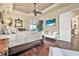 Well-lit main bedroom with hardwood floors, ceiling fan, and a cozy chaise lounge at 568 Luna Bella Ln, New Smyrna Beach, FL 32168