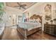 Beautiful main bedroom features hardwood floors, elegant lighting, and access to the en-suite bathroom at 568 Luna Bella Ln, New Smyrna Beach, FL 32168