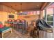 Outdoor bar with seating, grill, privacy wall, and serene sunset view at 568 Luna Bella Ln, New Smyrna Beach, FL 32168