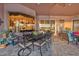 Covered outdoor dining area with seating for eight, stylish decor and sunset views at 568 Luna Bella Ln, New Smyrna Beach, FL 32168