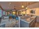 Outdoor kitchen with stone bar, seating, lighting, ceiling fans and comfortable outdoor seating at 568 Luna Bella Ln, New Smyrna Beach, FL 32168
