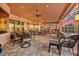 Spacious outdoor living area with ceiling fans, outdoor kitchen, comfortable seating and sunset view at 568 Luna Bella Ln, New Smyrna Beach, FL 32168