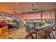 Covered outdoor living area with dining and seating areas and sunset view at 568 Luna Bella Ln, New Smyrna Beach, FL 32168