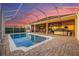 Private pool with a screened enclosure, brick paver deck, and sunset views at 568 Luna Bella Ln, New Smyrna Beach, FL 32168