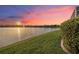 Scenic water view at sunset, showcasing vibrant colors, fountain, and lush landscaping at 568 Luna Bella Ln, New Smyrna Beach, FL 32168