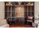 Custom wine cellar with diamond pattern storage racks, decorative lighting, and diamond pattern tiled backsplash at 568 Luna Bella Ln, New Smyrna Beach, FL 32168