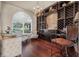 An elegant space with a custom wine cellar, chandelier, and an arched window providing natural light at 568 Luna Bella Ln, New Smyrna Beach, FL 32168