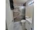 Bathroom with a tiled walk-in shower featuring a glass door and grab bars, modern vanity and toilet at 741 Ellen St, Daytona Beach, FL 32114