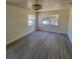 Bedroom with luxury vinyl plank flooring, ceiling fan and windows at 741 Ellen St, Daytona Beach, FL 32114