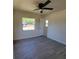 Comfortable bedroom with stylish gray flooring, natural light, and neutral wall color at 741 Ellen St, Daytona Beach, FL 32114