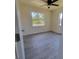Bright bedroom with stylish gray flooring, natural light, and neutral color scheme at 741 Ellen St, Daytona Beach, FL 32114