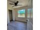 Cozy bedroom with a ceiling fan, wood-look floors, and a window offering natural light at 741 Ellen St, Daytona Beach, FL 32114