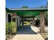 Attached carport features brick columns and green painted ceiling, offering convenient covered parking and curb appeal at 741 Ellen St, Daytona Beach, FL 32114