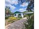 Charming home with green trim, a landscaped yard and long driveway leading up to the carport at 741 Ellen St, Daytona Beach, FL 32114