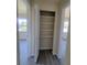 Hallway with linen closet and gray floors, seamlessly connecting different areas of the home at 741 Ellen St, Daytona Beach, FL 32114