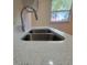 A close-up of a stainless steel kitchen sink with modern faucet and quartz countertops at 741 Ellen St, Daytona Beach, FL 32114