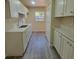 Kitchen with white cabinets, quartz countertops, stainless steel sink, and modern gray floors at 741 Ellen St, Daytona Beach, FL 32114