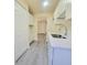 Galley kitchen with white cabinets, quartz countertops, and modern gray floors at 741 Ellen St, Daytona Beach, FL 32114