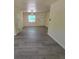 Open-concept living area with wood-look flooring, natural light, and a welcoming atmosphere at 741 Ellen St, Daytona Beach, FL 32114