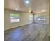Large, bright living room with sleek gray flooring and plenty of natural light from the windows at 741 Ellen St, Daytona Beach, FL 32114