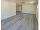 Bright living room featuring modern gray wood-look flooring and neutral walls at 741 Ellen St, Daytona Beach, FL 32114