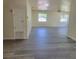 Spacious living room featuring sleek, modern gray flooring and natural light from the windows at 741 Ellen St, Daytona Beach, FL 32114