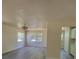 Living room with neutral colored walls, laminate flooring, ceiling fan, and two windows at 741 Ellen St, Daytona Beach, FL 32114