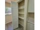 Open pantry with bright white shelving next to marble countertops and drawers at 741 Ellen St, Daytona Beach, FL 32114