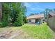 Green backyard with patio and seating adjacent to sliding glass door at 915 Stonybrook Cir, Port Orange, FL 32127