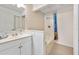 Bathroom featuring a single sink vanity, tiled bathtub, and shower with colorful curtain at 915 Stonybrook Cir, Port Orange, FL 32127