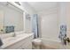 Bright bathroom with white vanity, mirror, tub/shower combo, and blue-themed accents at 915 Stonybrook Cir, Port Orange, FL 32127