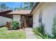 Inviting front entrance with well-maintained landscaping and a charming, light-colored exterior at 915 Stonybrook Cir, Port Orange, FL 32127