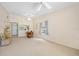 Spacious living room with carpet, ceiling fans, and access to dining area with pass-through window at 915 Stonybrook Cir, Port Orange, FL 32127