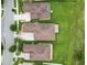 An aerial view of the well-maintained homes featuring lush lawns and mature landscaping at 3345 Tesoro Cir, New Smyrna Beach, FL 32168