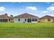 The backyard features a well-maintained lawn, a screened lanai, and is ideal for outdoor activities at 3345 Tesoro Cir, New Smyrna Beach, FL 32168