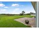 Spacious backyard featuring lush green grass, brick-paved patio, and a large flower pot at 3345 Tesoro Cir, New Smyrna Beach, FL 32168