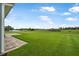 A spacious backyard featuring lush green grass and a brick paved patio at 3345 Tesoro Cir, New Smyrna Beach, FL 32168