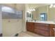 Bright bathroom features wood cabinets, double sinks, walk-in shower and tile flooring at 3345 Tesoro Cir, New Smyrna Beach, FL 32168