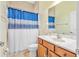 Well-lit bathroom with shower and single sink vanity at 3345 Tesoro Cir, New Smyrna Beach, FL 32168
