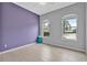 Comfortable bedroom with wood-look tile flooring and bright windows at 3345 Tesoro Cir, New Smyrna Beach, FL 32168