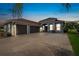 Charming home featuring a three-car garage, a well manicured lawn and lovely tropical landscaping at 3345 Tesoro Cir, New Smyrna Beach, FL 32168