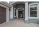 The columned entry features a decorative glass door and well-maintained concrete landing at 3345 Tesoro Cir, New Smyrna Beach, FL 32168