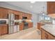 Modern kitchen featuring stainless appliances, granite countertops, and tile flooring at 3345 Tesoro Cir, New Smyrna Beach, FL 32168