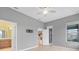 Bright main bedroom with ceiling fan, tile floors, and adjoining bath at 3345 Tesoro Cir, New Smyrna Beach, FL 32168
